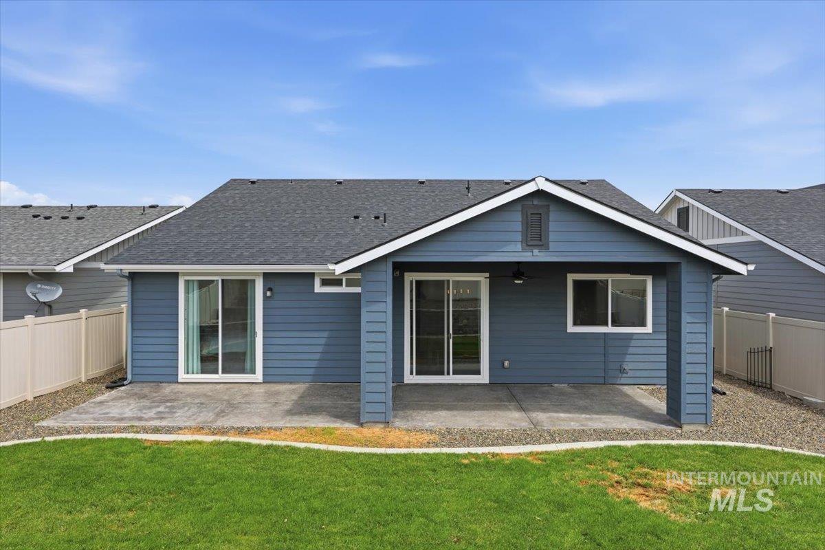 5897 West Riva Capri Street Meridian, ID 83646 - Photo 41 of 50 Rear elevation featuring blue siding, white trim, and a covered patio with a concrete surface