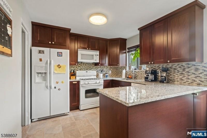 404-406 Chestnut Street Newark, NJ 07105 - Photo 14 of 27 a kitchen with stainless steel appliances granite countertop a refrigerator stove and sink