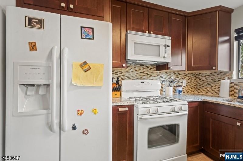 404-406 Chestnut Street Newark, NJ 07105 - Photo 15 of 27 a kitchen with a refrigerator sink stove and cabinets