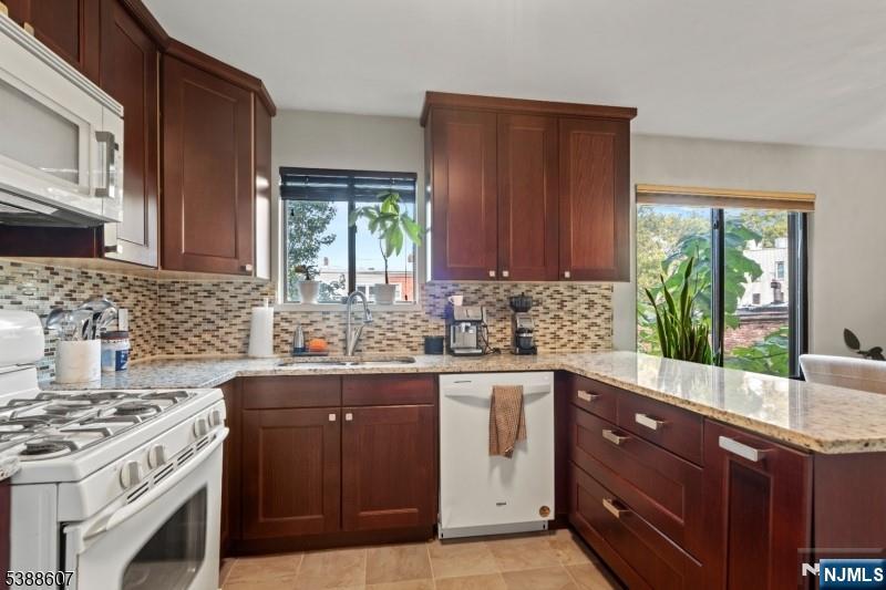 404-406 Chestnut Street Newark, NJ 07105 - Photo 16 of 27 a kitchen with a sink stove and cabinets