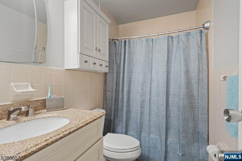 404-406 Chestnut Street Newark, NJ 07105 - Photo 24 of 27 a bathroom with a granite countertop sink toilet and shower