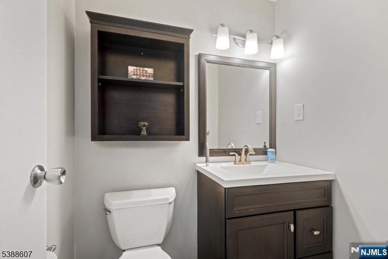 404-406 Chestnut Street Newark, NJ 07105 - Photo 9 of 27 a bathroom with a toilet sink and mirror