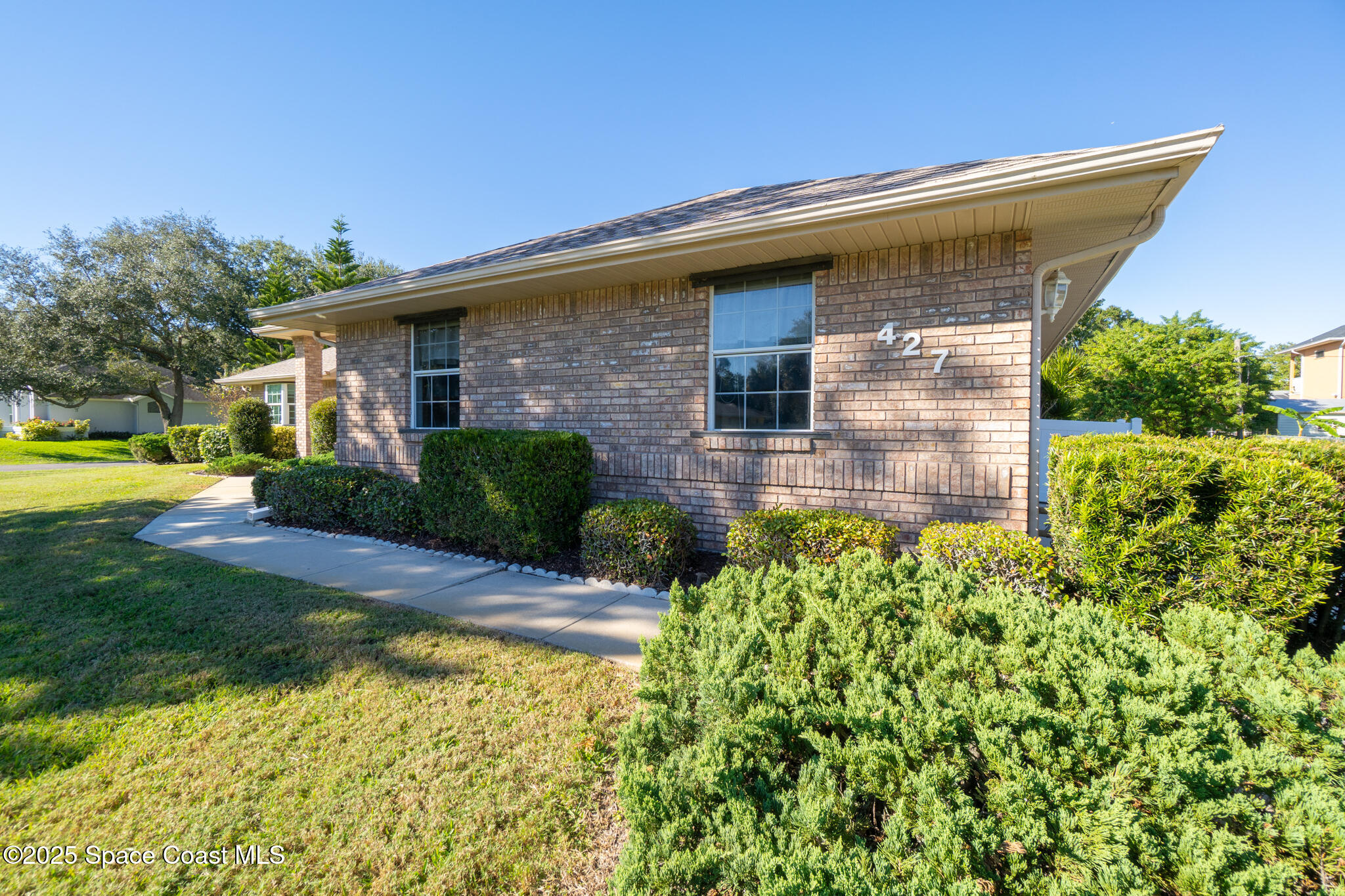 427 Hurst Road Northeast Palm Bay, FL 32907 - Photo 12 of 81 a front view of a house with garden