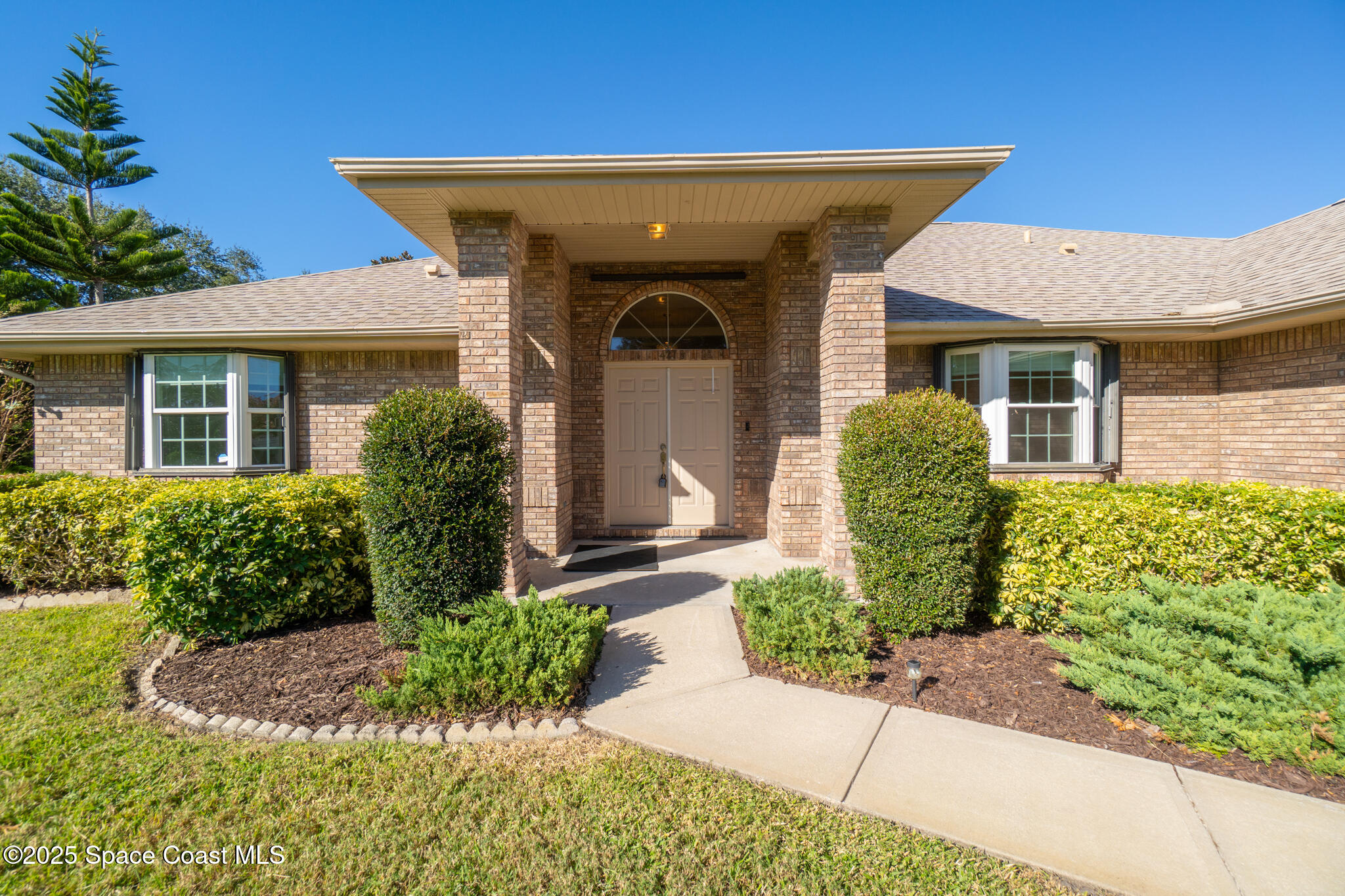 427 Hurst Road Northeast Palm Bay, FL 32907 - Photo 14 of 81 a front view of a house with garden