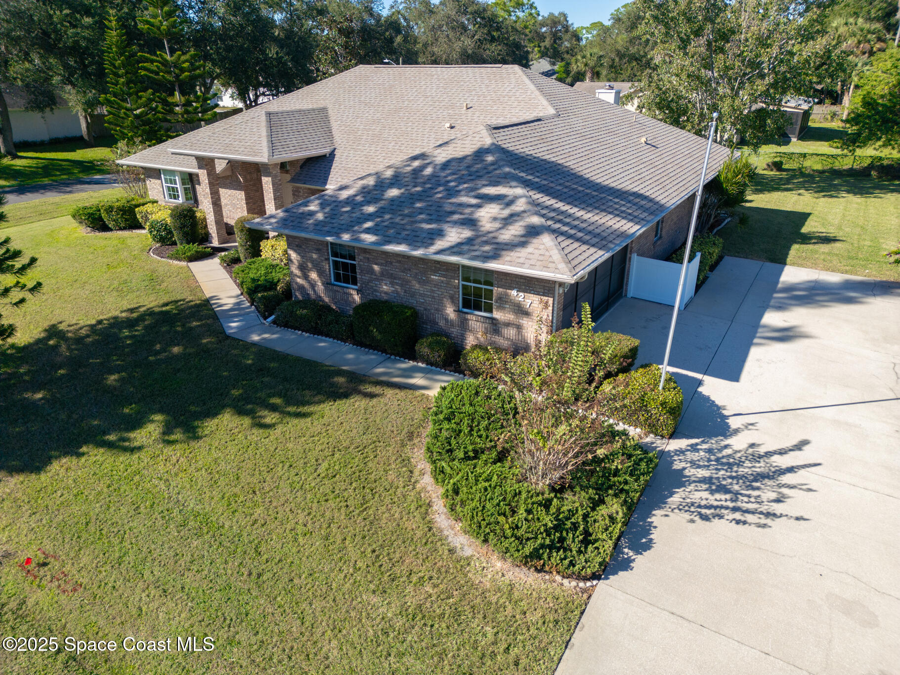 427 Hurst Road Northeast Palm Bay, FL 32907 - Photo 2 of 81 a view of a house with a yard and potted plants