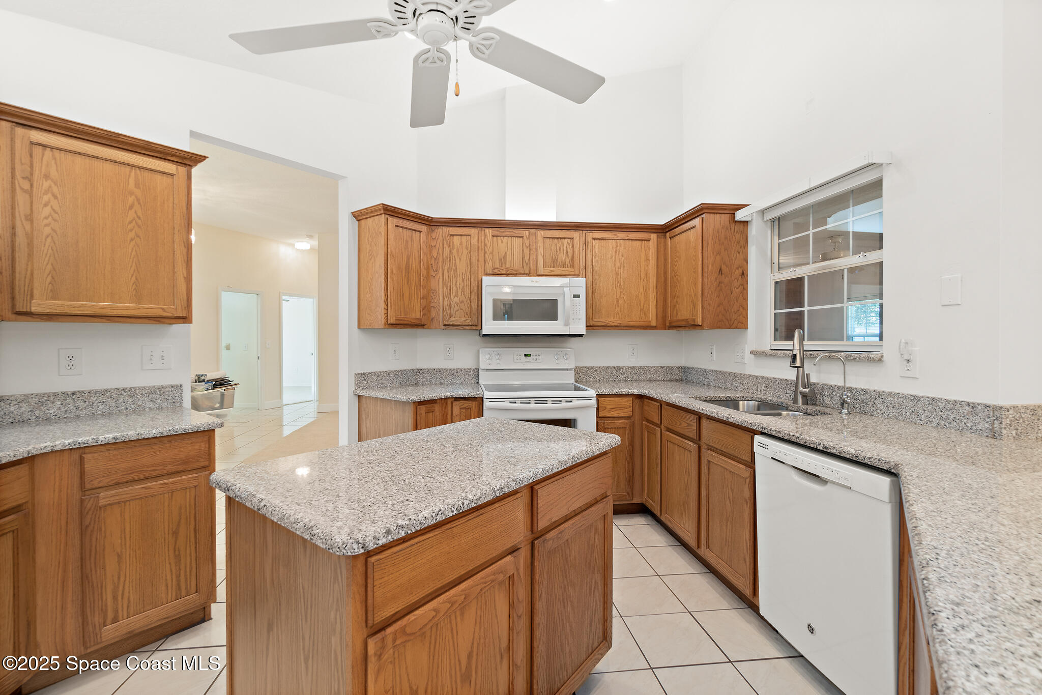 427 Hurst Road Northeast Palm Bay, FL 32907 - Photo 26 of 81 a kitchen with granite countertop a sink and cabinets