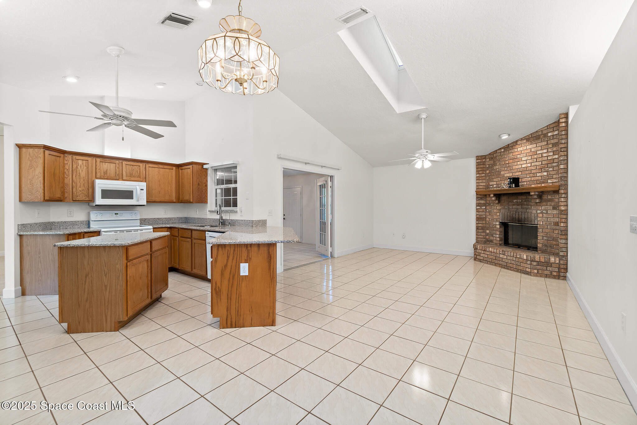 427 Hurst Road Northeast Palm Bay, FL 32907 - Photo 28 of 81 a large kitchen with stainless steel appliances granite countertop a sink counter space cabinets and stainless steel appliances