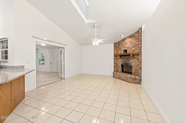 a view of a big room with wooden floor and windows in a room