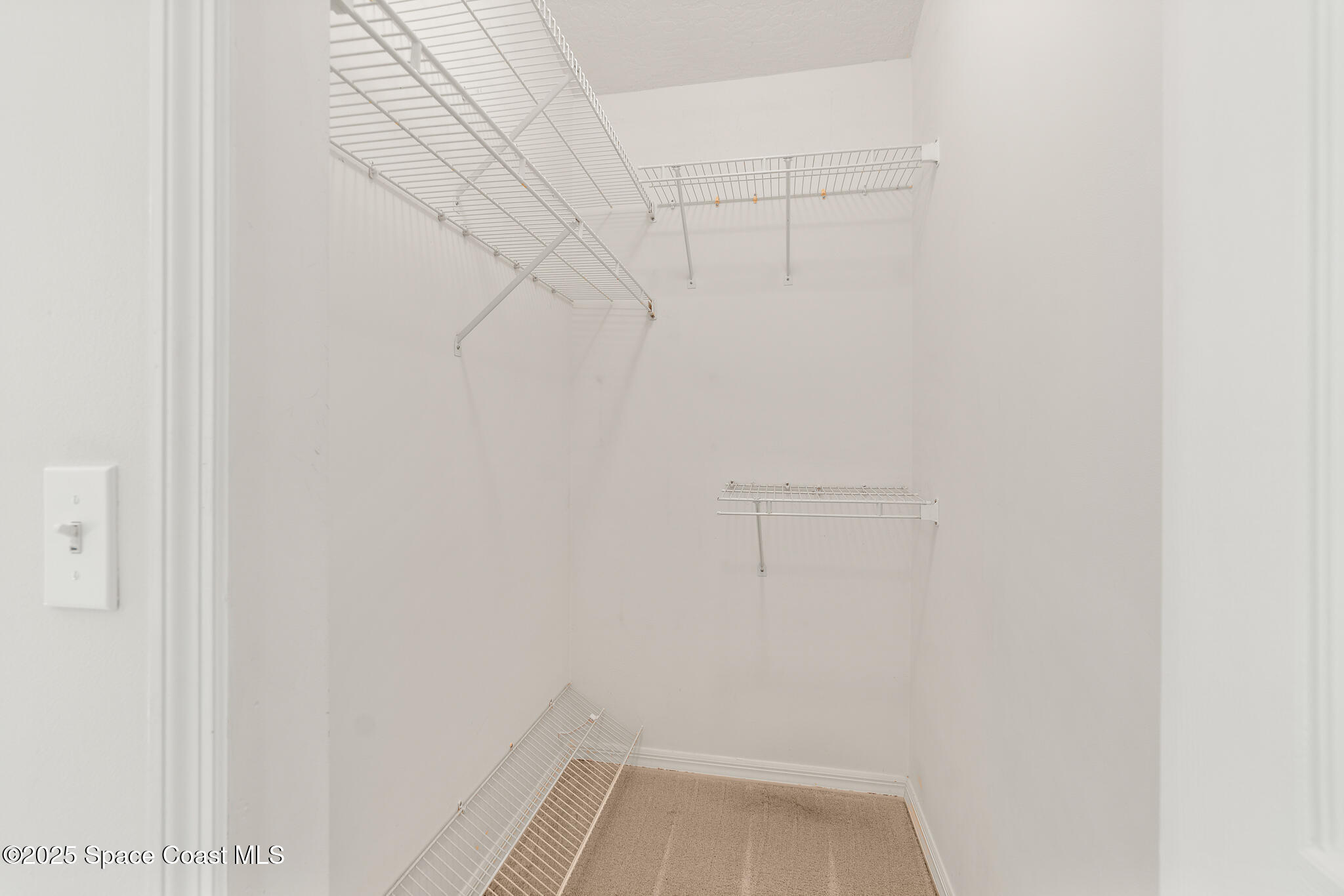 427 Hurst Road Northeast Palm Bay, FL 32907 - Photo 35 of 81 a view of a room with racks on the wall