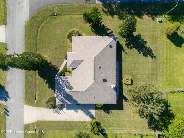 an aerial view of a house with a swimming pool