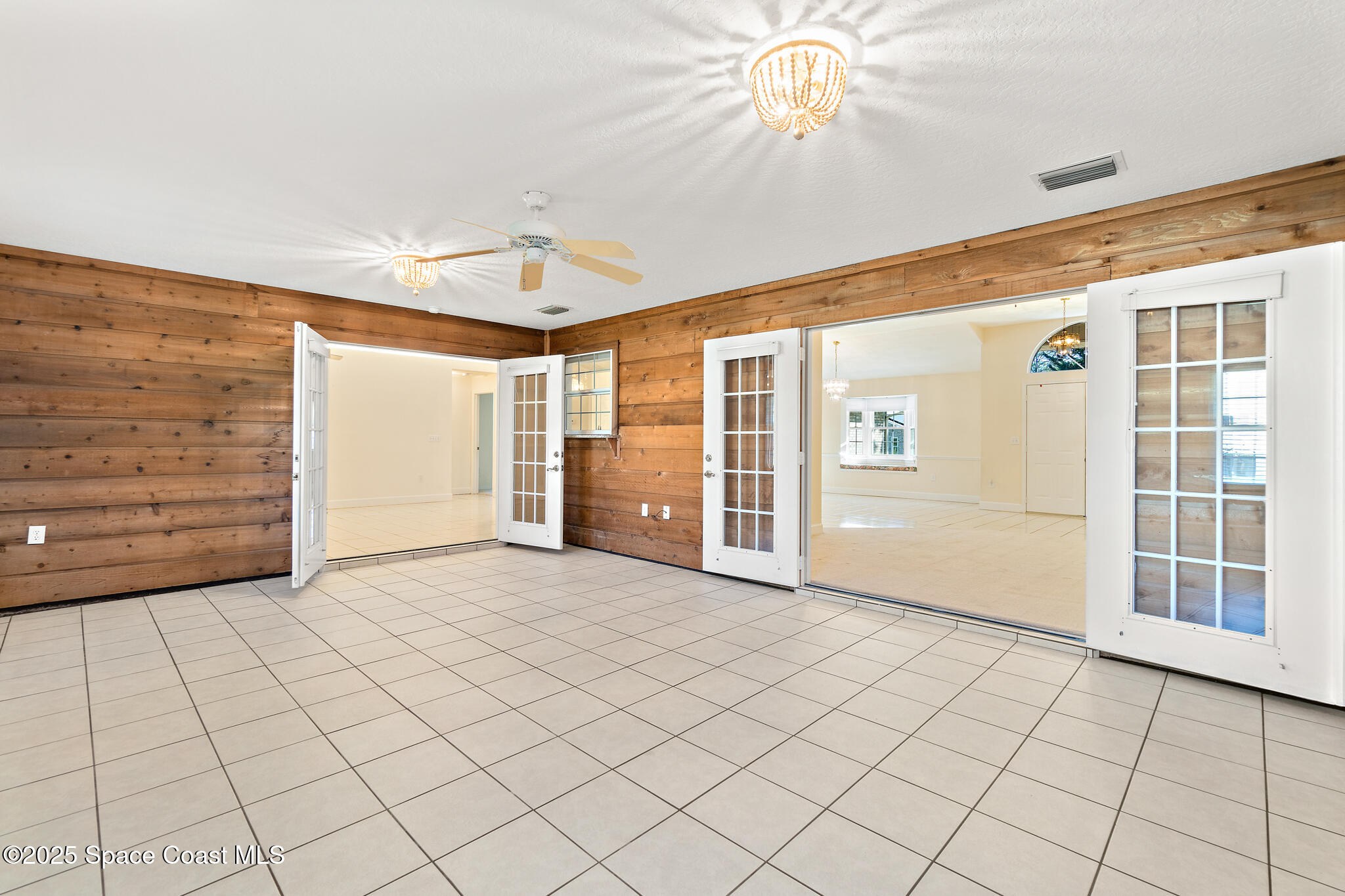 427 Hurst Road Northeast Palm Bay, FL 32907 - Photo 41 of 81 a view of an empty room with window and chandelier fan
