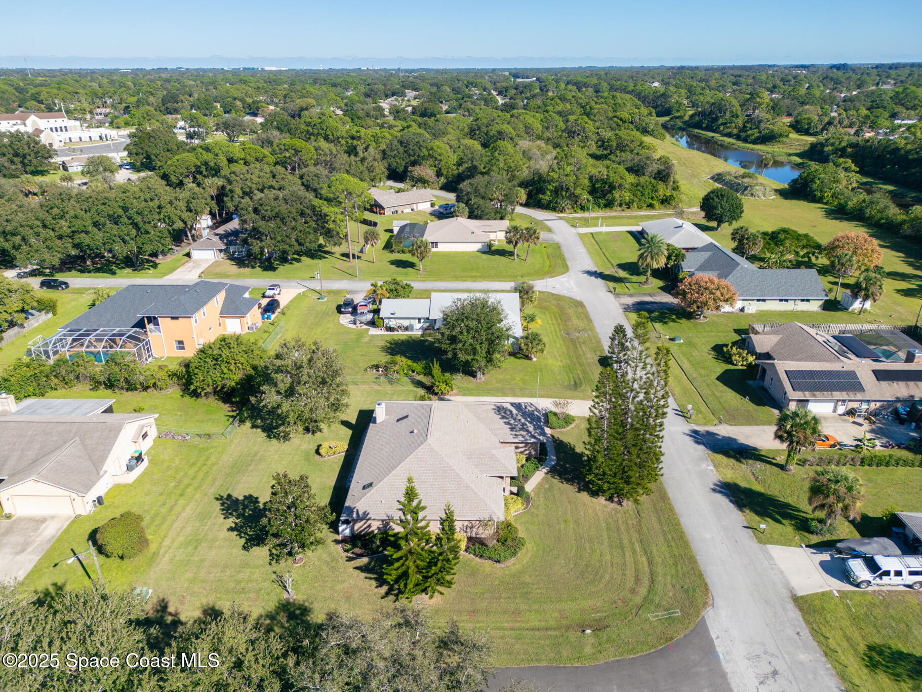 427 Hurst Road Northeast Palm Bay, FL 32907 - Photo 75 of 81 an aerial view of residential houses with outdoor space and swimming pool