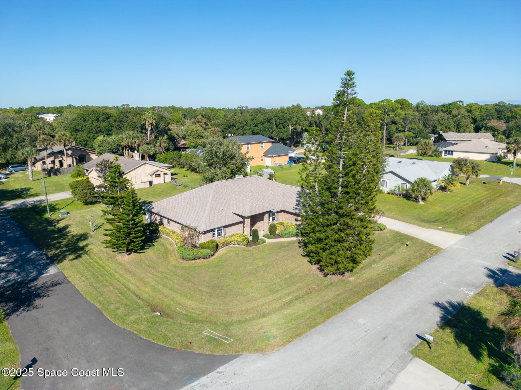 427 Hurst Road Northeast Palm Bay, FL 32907 - Photo 9 of 81 an aerial view of residential houses with outdoor space and trees