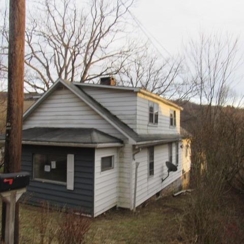 3097 Seanor Road Hollsopple, PA 15935 - Photo 2 of 15 a view of a white house with a large tree