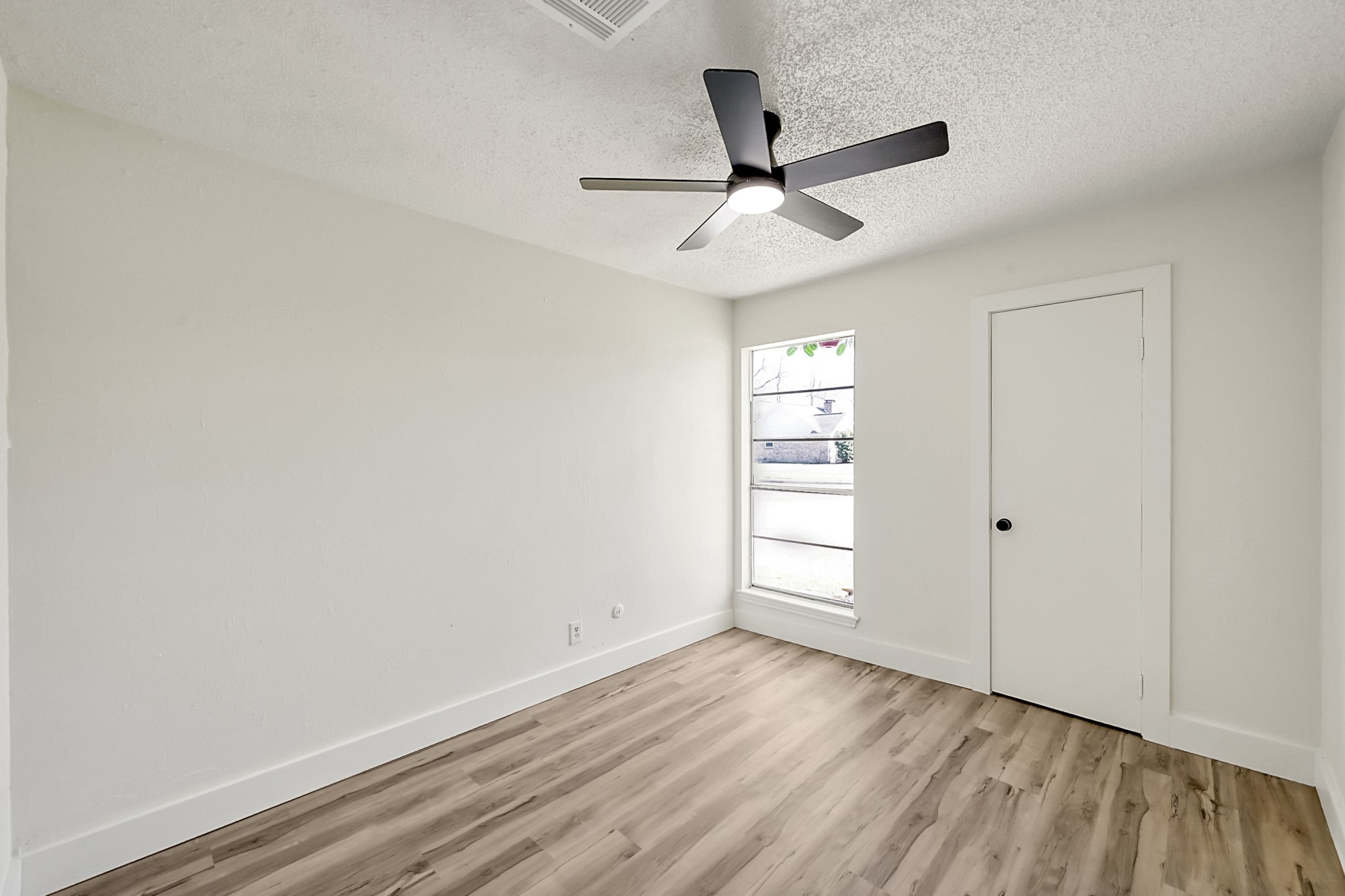29615 Brookchase Drive Spring, TX 77386 - Photo 19 of 24 This room features neutral walls, a modern ceiling fan, and a window offering natural light. Ideal for a cozy bedroom or home office. This secondary bedroom faces the front of the home.