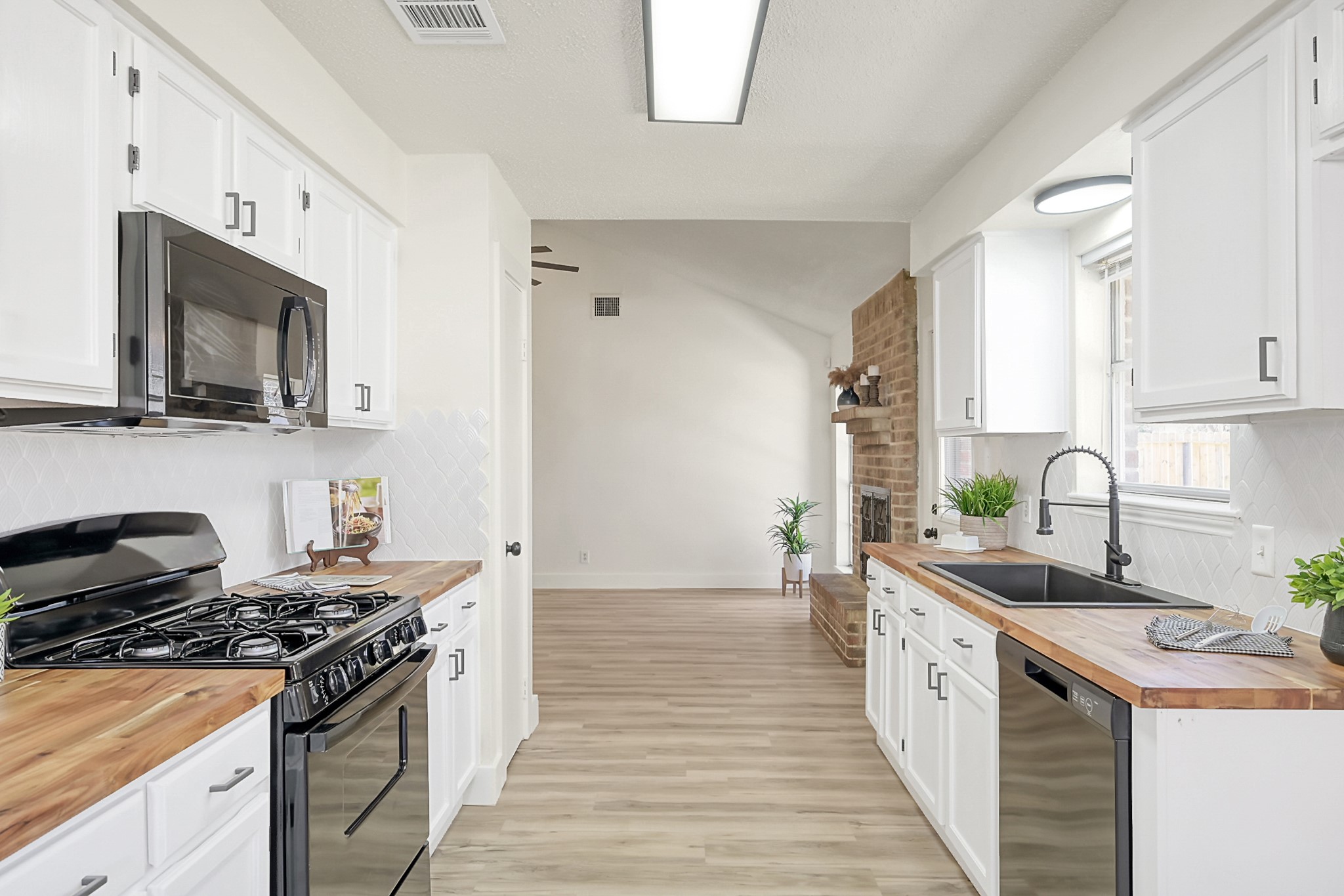 29615 Brookchase Drive Spring, TX 77386 - Photo 10 of 24 This kitchen features a black farmhouse sink, and the space flows into the living area.