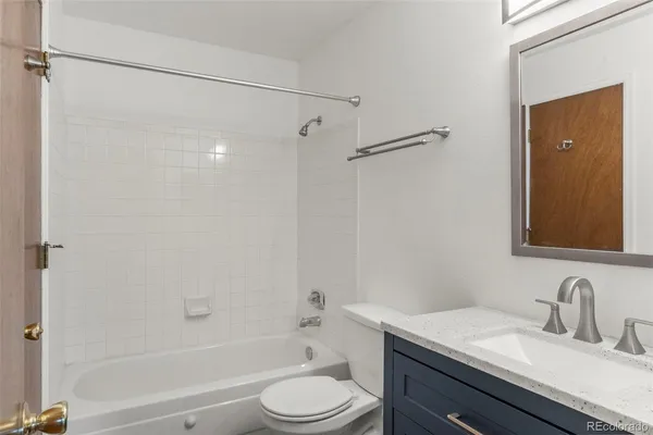 a bathroom with a sink toilet vanity and shower
