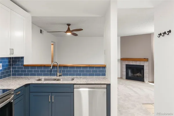 a kitchen with a sink and a refrigerator