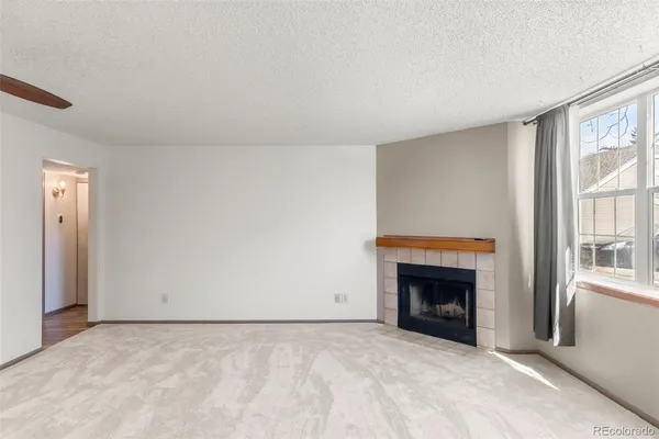 a view of empty room with a fireplace