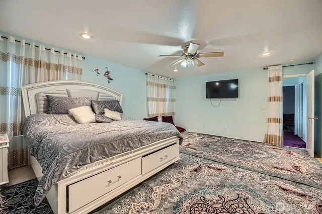 a bedroom with a bed and a flat screen tv