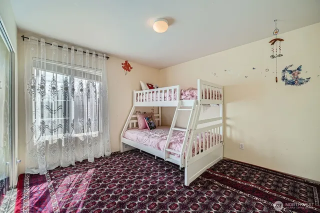 a bedroom with bed and a window