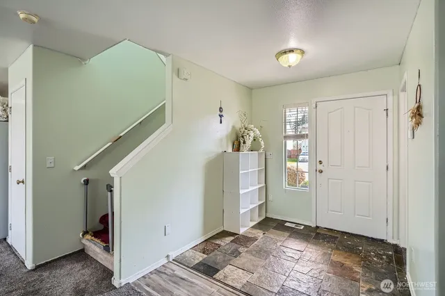 a view of a livingroom with stairs and furniture