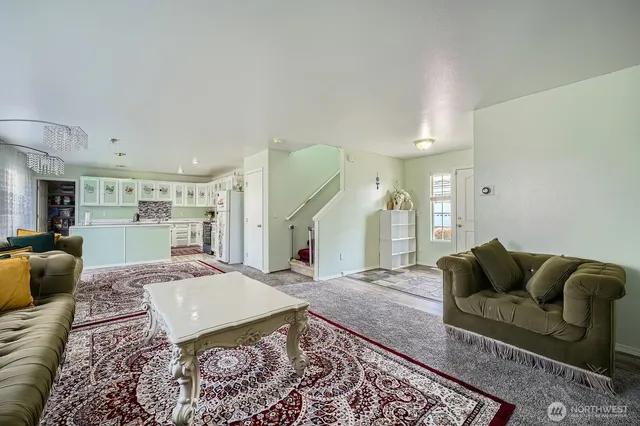 a living room with furniture rug and a table