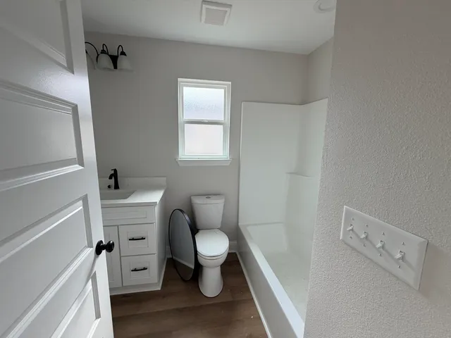 a white toilet sitting next to a bathroom sink