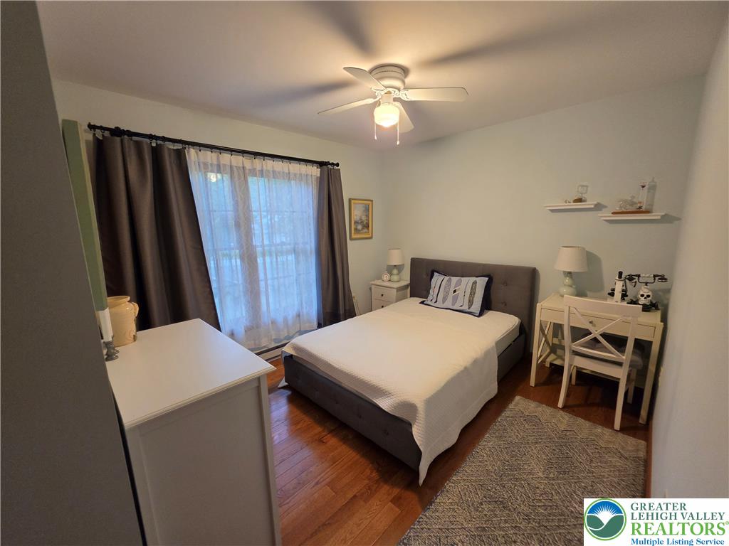 211 Murphy Circle Bushkill, PA 18324 - Photo 19 of 28 Hardwood floors and a ceiling fan create a comfortable ambiance in this inviting bedroom.