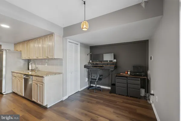 a kitchen with stainless steel appliances granite countertop a refrigerator a stove top oven a sink and dishwasher