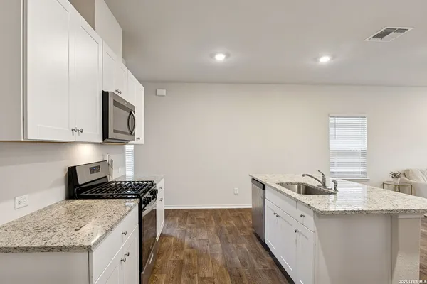 a kitchen that has a sink and a stove in it