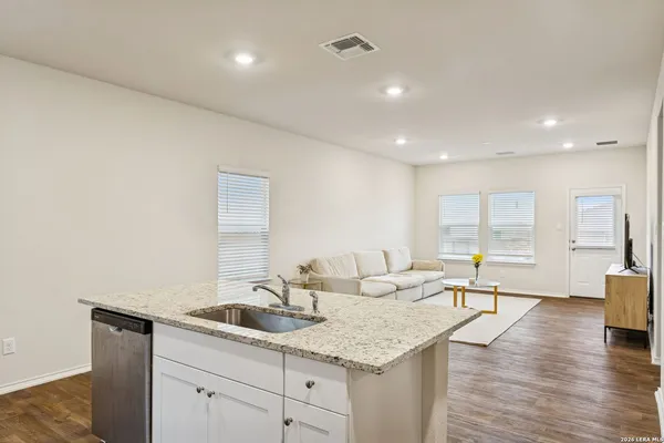 a living room with granite countertop furniture and wooden floor