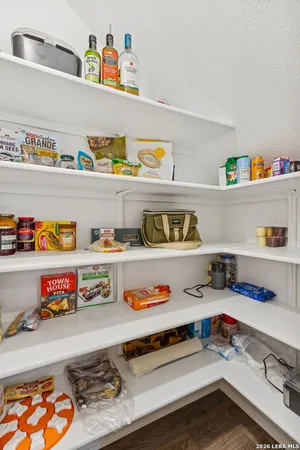 a utility room with stainless steel appliances lots of clutter