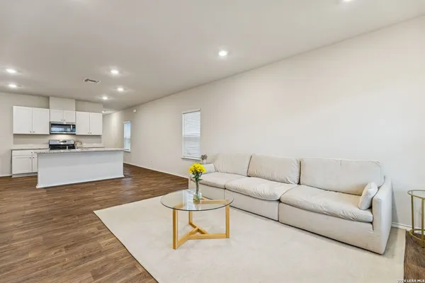 a living room with furniture and kitchen view