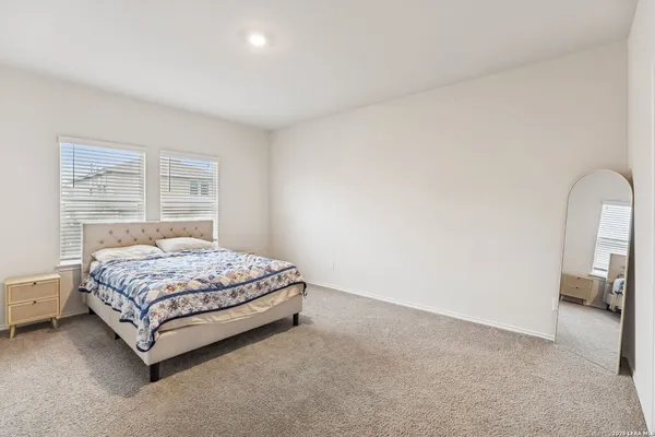 a bedroom with a bed lamp and a window