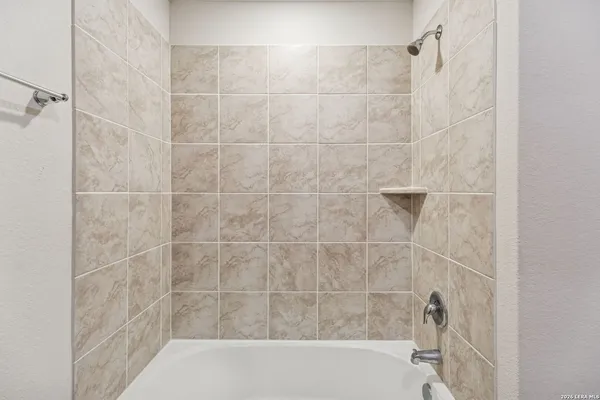 a bathroom with a shower and a shower