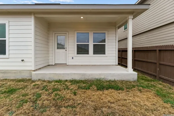 a view of house with backyard space and a window