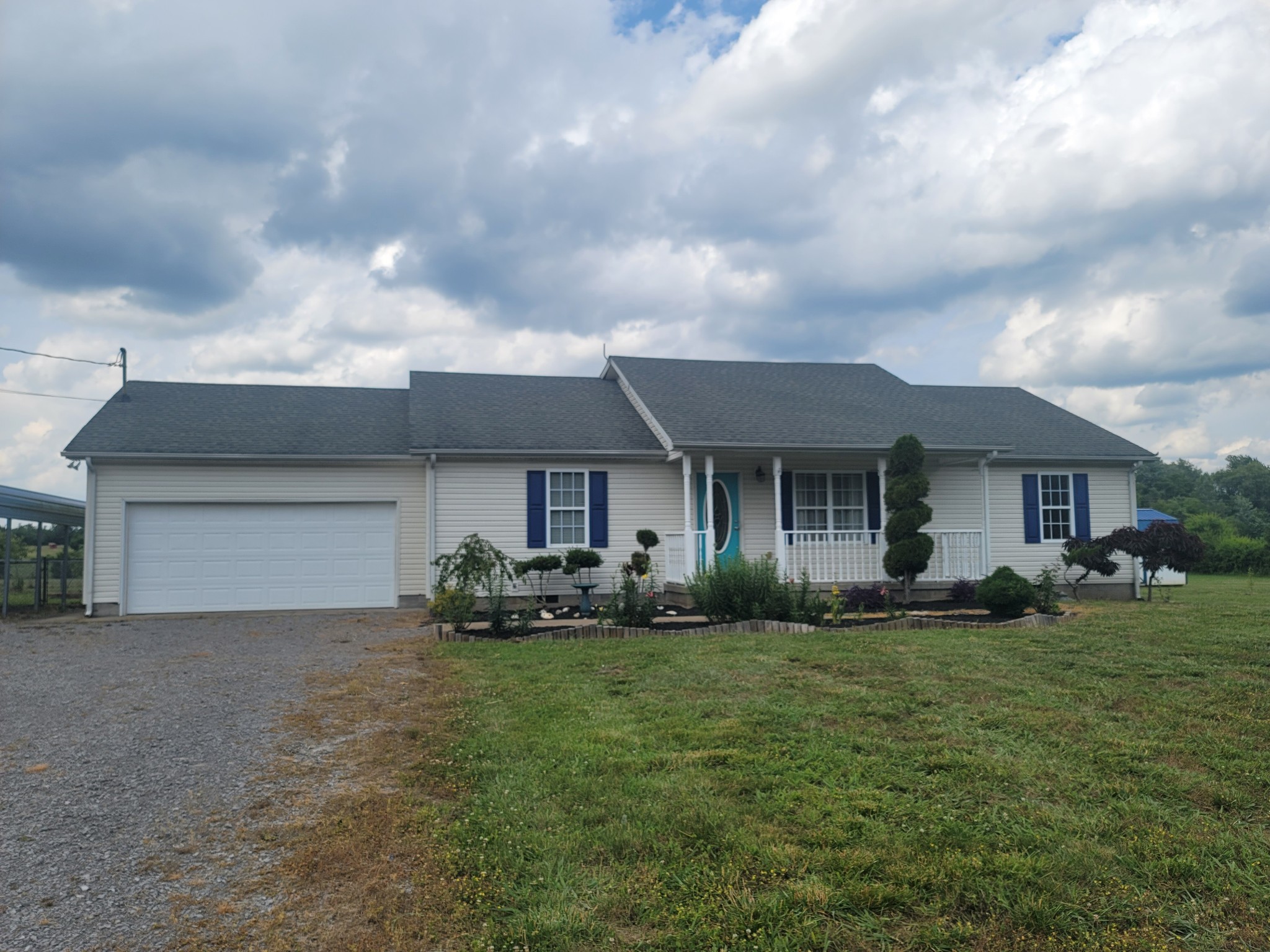 137 Sudberry Road Bell Buckle, TN 37020 - Photo 4 of 39 a front view of a house with a yard and garage