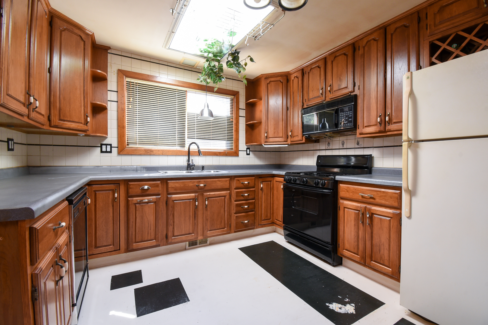 206 Circle Road Fox River Grove, IL 60021 - Photo 11 of 40 a kitchen with stainless steel appliances granite countertop a stove a sink and a microwave