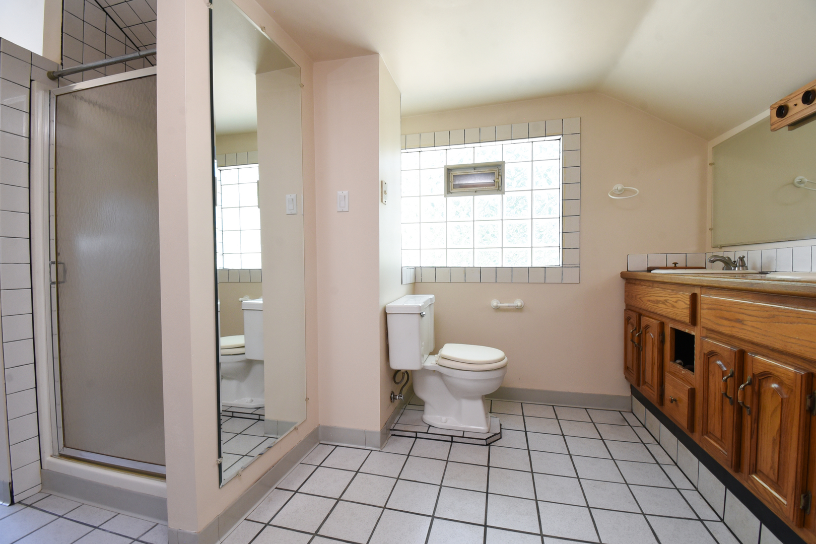 206 Circle Road Fox River Grove, IL 60021 - Photo 27 of 40 a bathroom with a toilet a sink a window and mirror