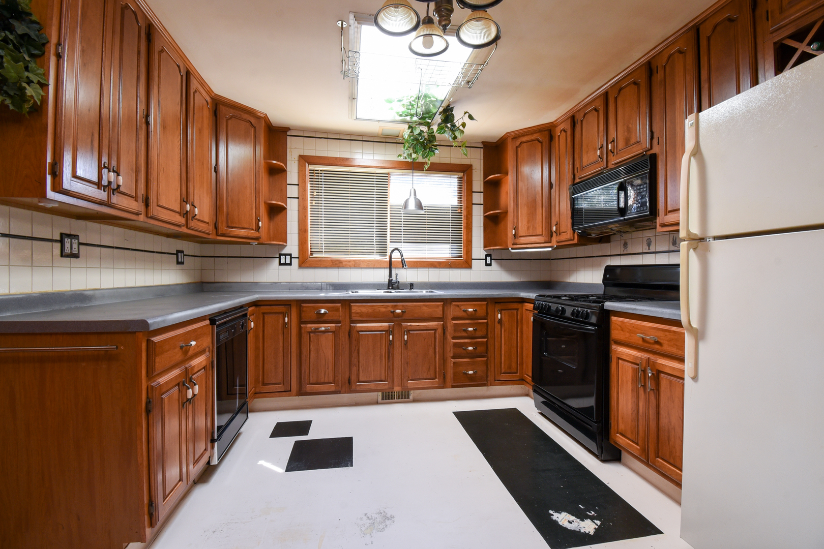 206 Circle Road Fox River Grove, IL 60021 - Photo 10 of 40 a kitchen with stainless steel appliances granite countertop a stove a sink dishwasher and a refrigerator with wooden cabinets