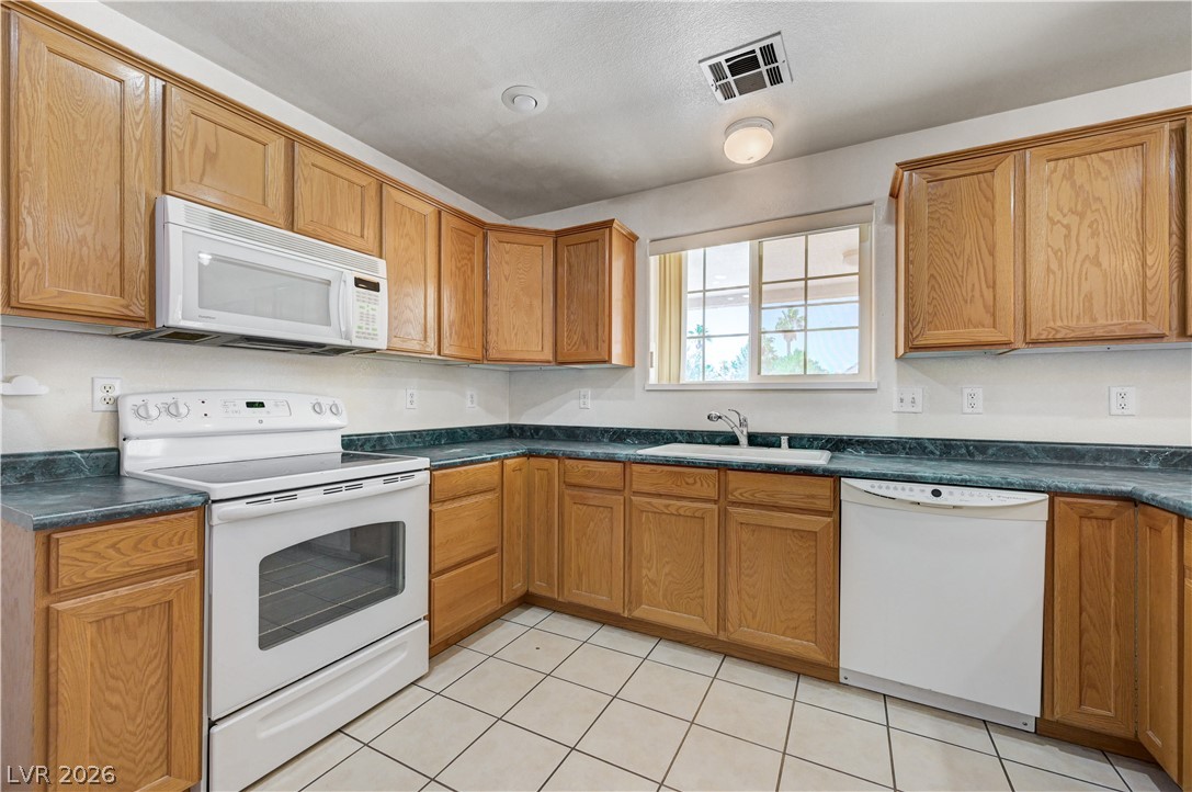 1272 Liston Avenue Logandale, NV 89021 - Photo 24 of 61 A well-appointed kitchen offers functional appliances and ample cabinetry.