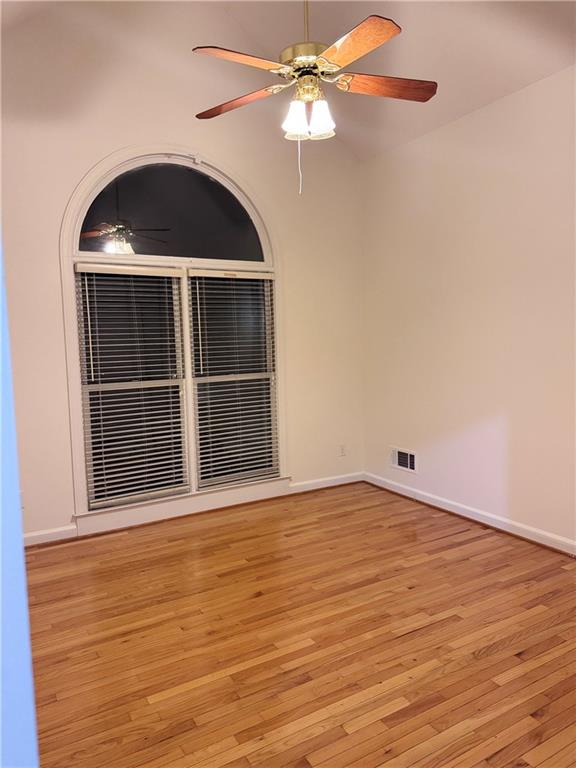 115 Parkview Trace Pass Southwest Lilburn, GA 30047 - Photo 14 of 19 a view of an empty room with wooden floor and a window