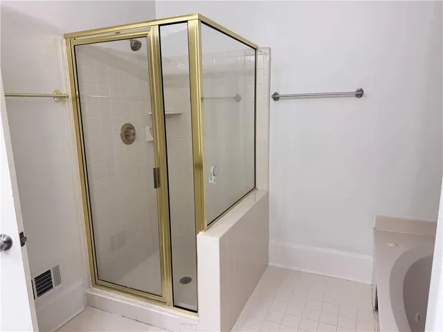 a bathroom with a shower and a tub