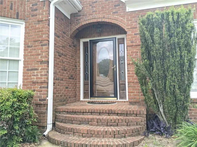 a front view of a house with a garden