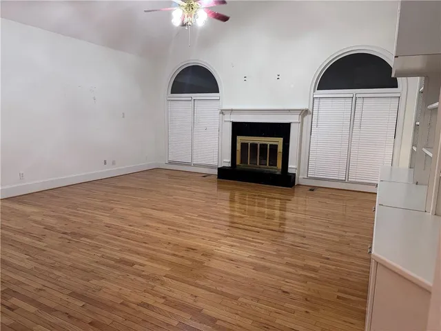 wooden floor in an empty room with a fireplace