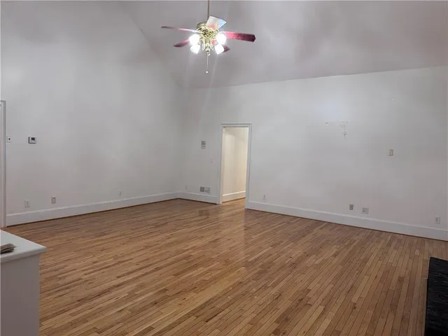 a view of room with wooden floor