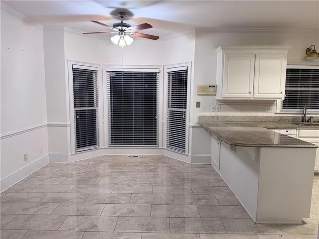 a view of a kitchen with a sink and cabinets