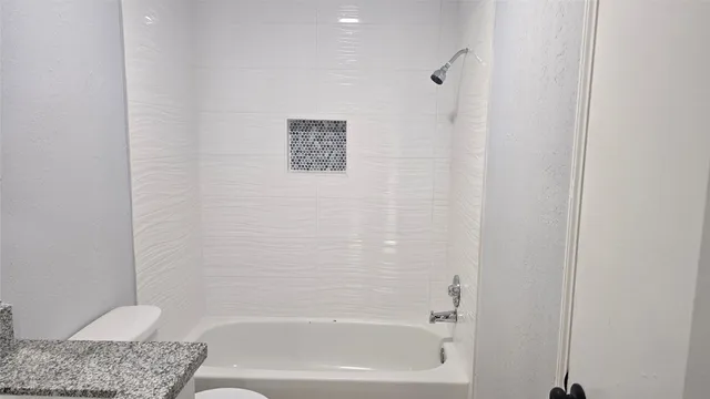 a bathroom with a shower and a bath tub