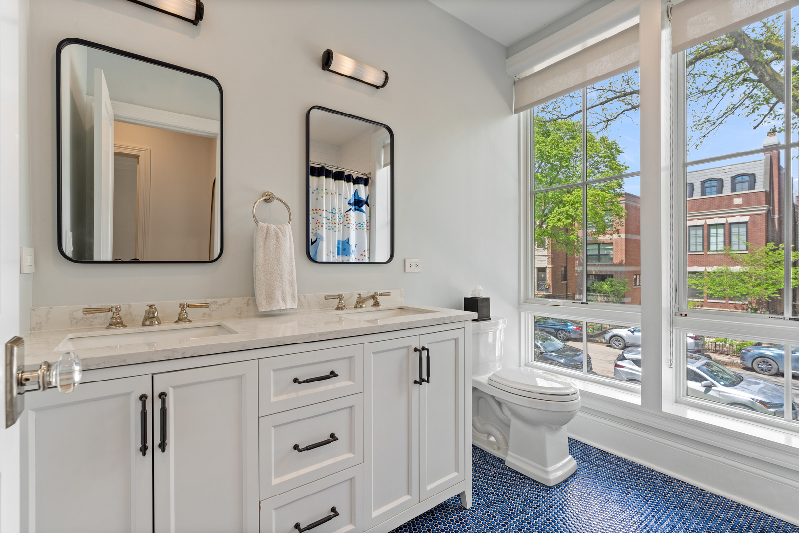 1025 West Altgeld Street Chicago, IL 60614 - Photo 22 of 41 a bathroom with a toilet a sink a large mirror and a window